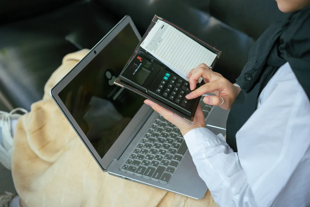 UAE business professional reviewing an accounting dashboard showing VAT return summary and corporate tax liabilities for a Dubai SMB