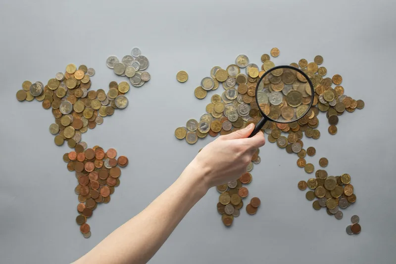 View of coins arranged in a world map shape — illustrating the UAE's network of double taxation agreements spanning more than 130 countries globally