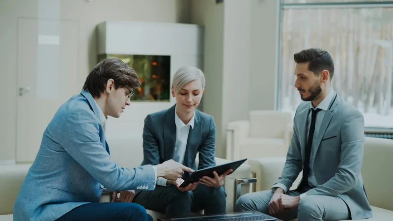 A Dubai-based business owner reviewing an accounting proposal with a financial consultant, comparing service tiers and costs