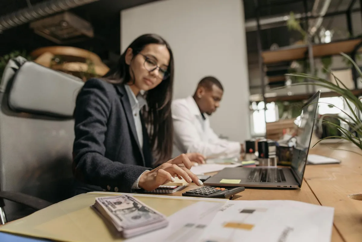 Accountant reviewing financial statements and VAT records at a desk in a Dubai office