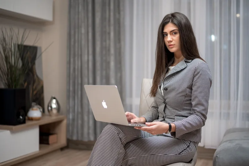 Professional woman working on a laptop indoors